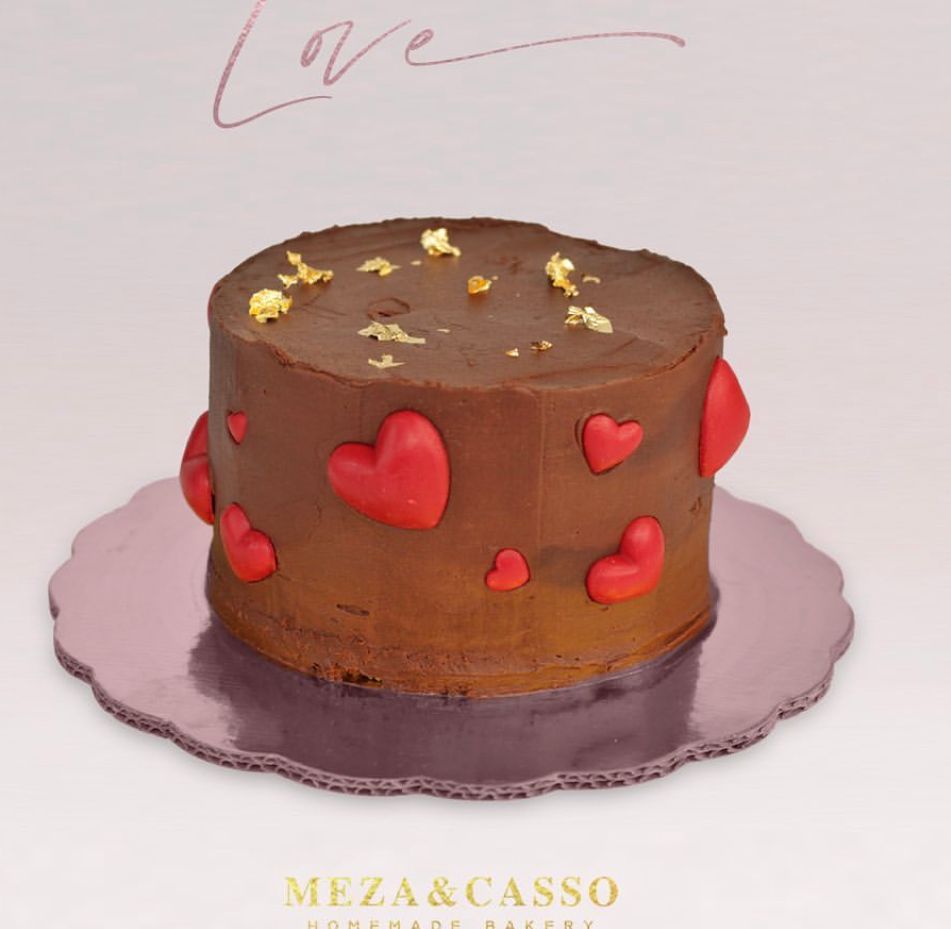 Pastel de chocolate con corazones rojos y pan de oro